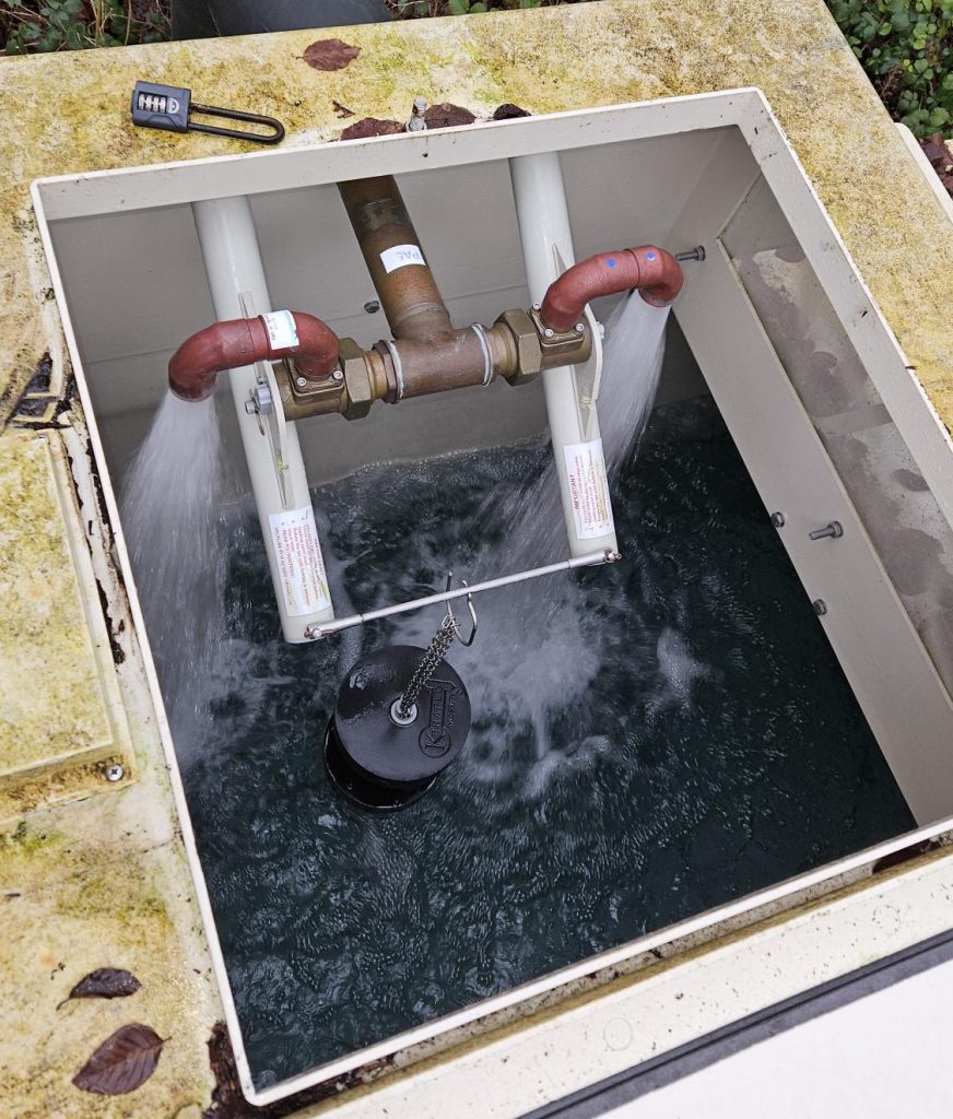 A picture of a cold water storage tank, also known as a break tank, with the pumps filling it with water