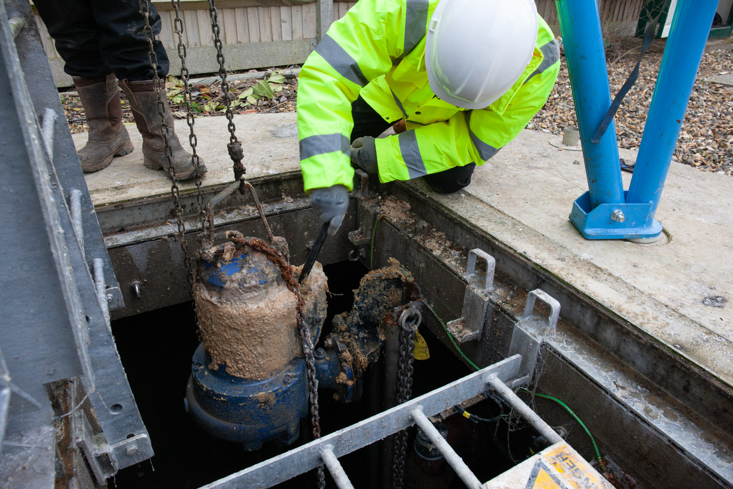 A Willow Pumps engineer servicing a below ground pump to remove scum and extend the life of the pump